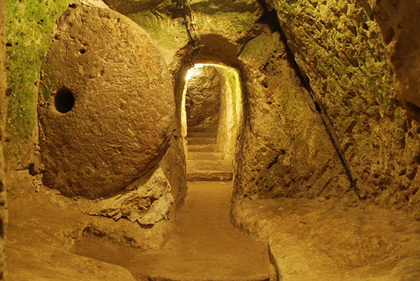 The underground city at Derinkuyu is the largest of several similar cities in Cappadocia. It may have been built as early as the 8th century BCE and was used by various populations over the centuries during times of invasion or persecution. This underground city could house 20,000 people along with their livestock.