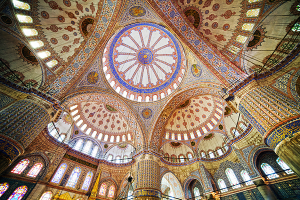 The Blue Mosque gets its nickname from the 20,000 hand-painted tiles that adorn the interior. It's a peaceful, uplifting space, where visitors (minus their shoes) are welcome to lounge on the carpet and soak up the splendor. The Blue Mosque pairs perfectly with the Hagia Sophia. Each is representative of a very different period in the city's history and very different ways of expressing religious devotion and state power. 