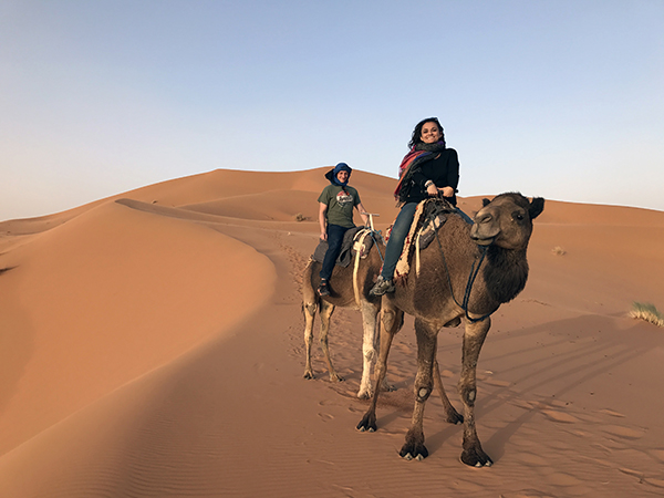 Ya'lla travelers enjoy a Sahara sunrise camel ride on their Morocco vacation