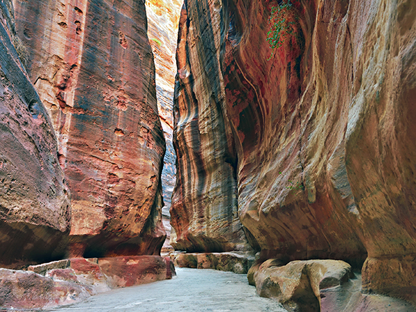 Petra is entered through a deep and narrow gorge or Siq, a natural fissure in the rock that winds for about 3/4 of a mile.